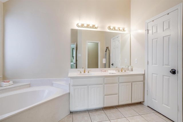 bathroom featuring tile patterned floors, a washtub, and vanity