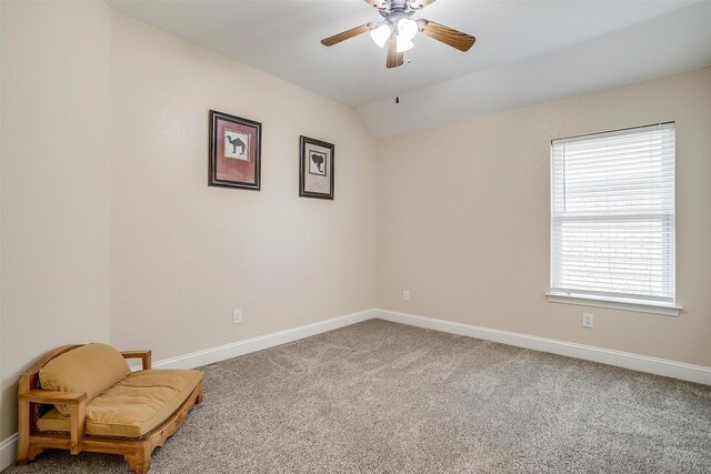 spare room featuring ceiling fan, carpet floors, and lofted ceiling