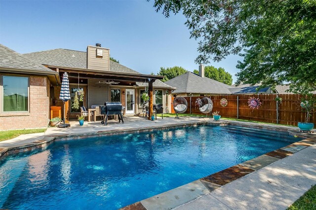 view of swimming pool featuring a patio, ceiling fan, and a grill