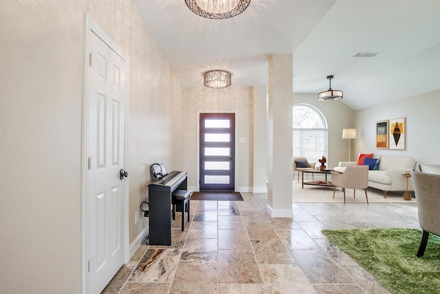 entryway featuring lofted ceiling