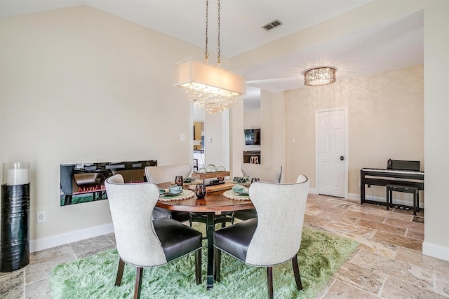 dining space featuring a chandelier and lofted ceiling