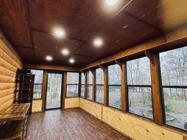 unfurnished sunroom with wooden ceiling