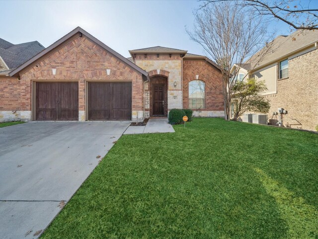 view of front of property featuring a garage and a front lawn