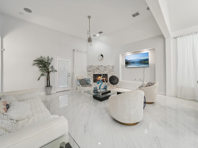 living room with a tile fireplace