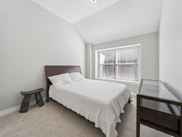 carpeted bedroom featuring vaulted ceiling