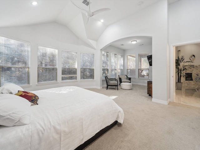 carpeted bedroom featuring high vaulted ceiling