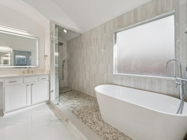 bathroom featuring lofted ceiling, shower with separate bathtub, tile walls, plenty of natural light, and vanity