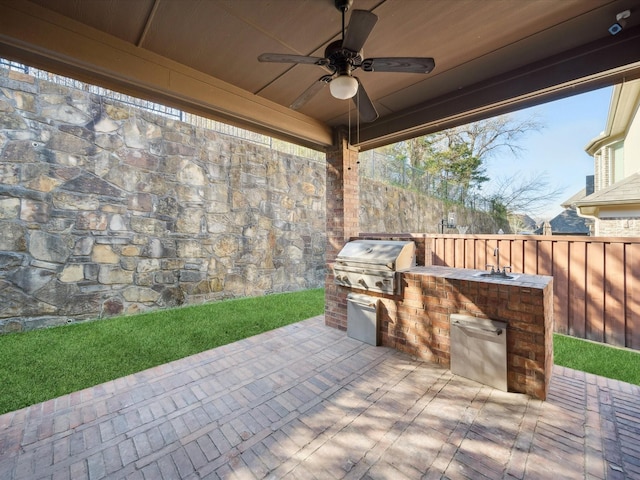 view of patio / terrace with ceiling fan, area for grilling, sink, and grilling area