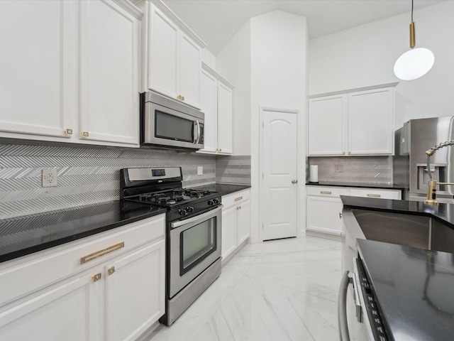 kitchen featuring stainless steel appliances, hanging light fixtures, white cabinets, and backsplash