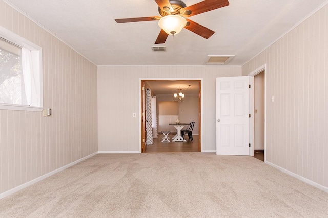 empty room featuring carpet flooring and ceiling fan with notable chandelier