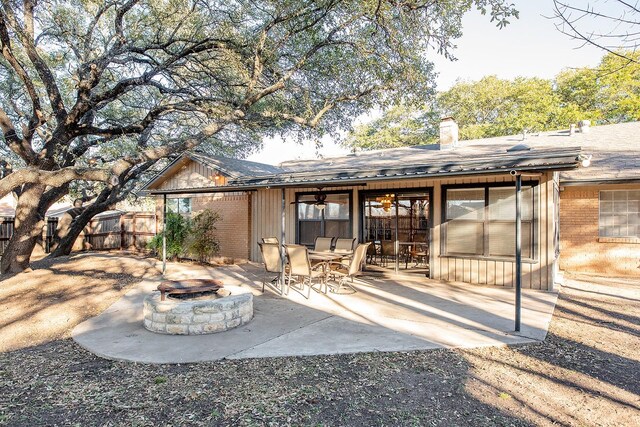 back of property featuring a fire pit and a patio