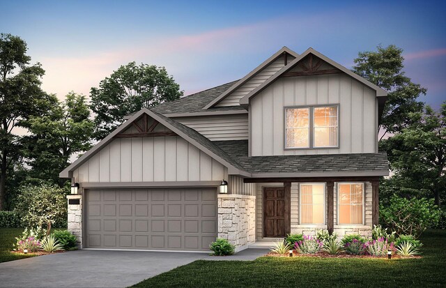 view of front of home with a lawn and a garage