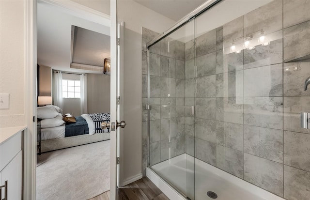 bathroom with wood-type flooring and an enclosed shower