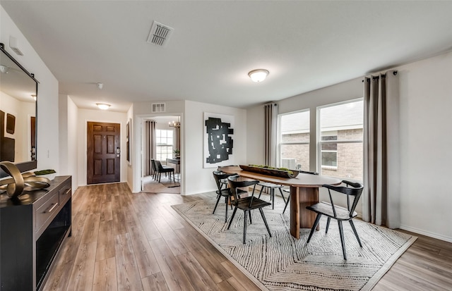 dining space with plenty of natural light and light wood-type flooring