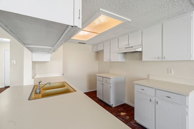 kitchen with white cabinets, dark hardwood / wood-style floors, and sink