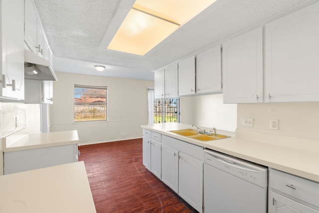 kitchen with white cabinets, dishwasher, sink, and a textured ceiling