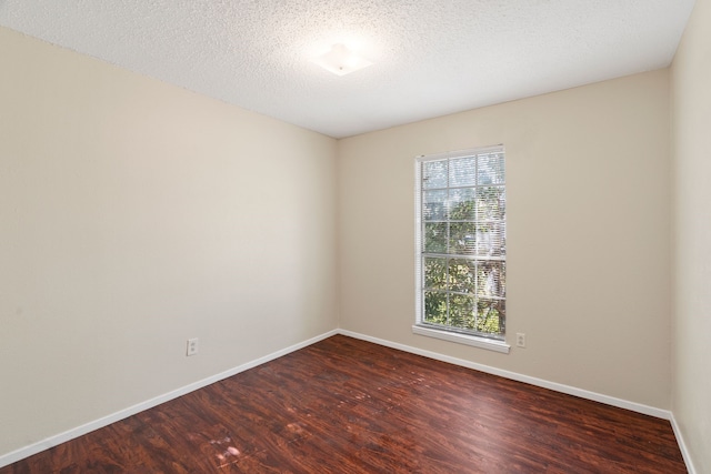 spare room with wood-type flooring and a textured ceiling