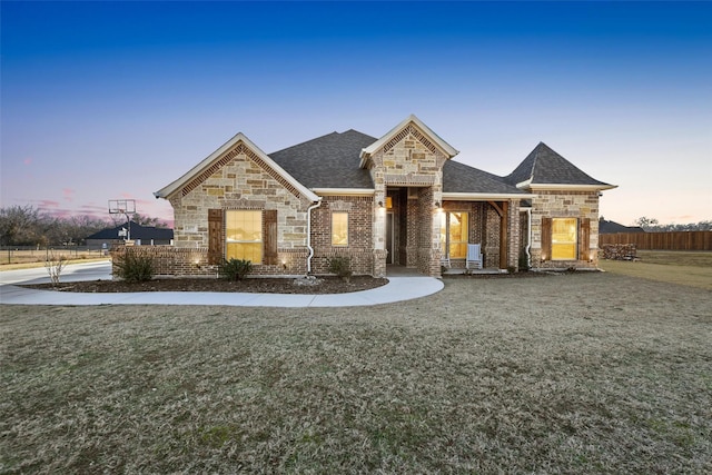 french country style house with a front yard