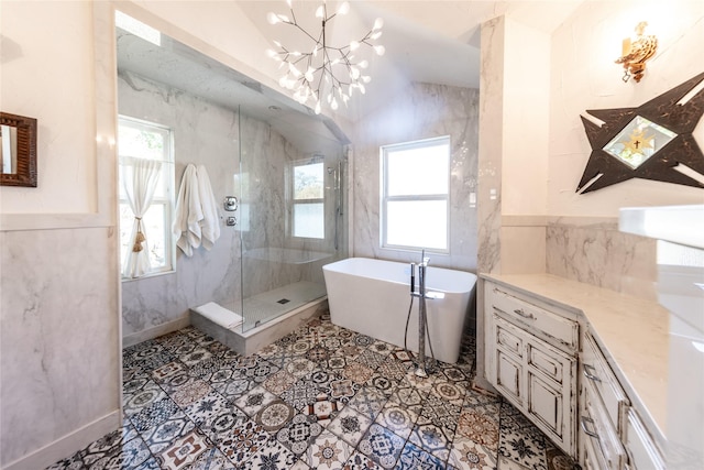 bathroom with a notable chandelier, separate shower and tub, and vaulted ceiling