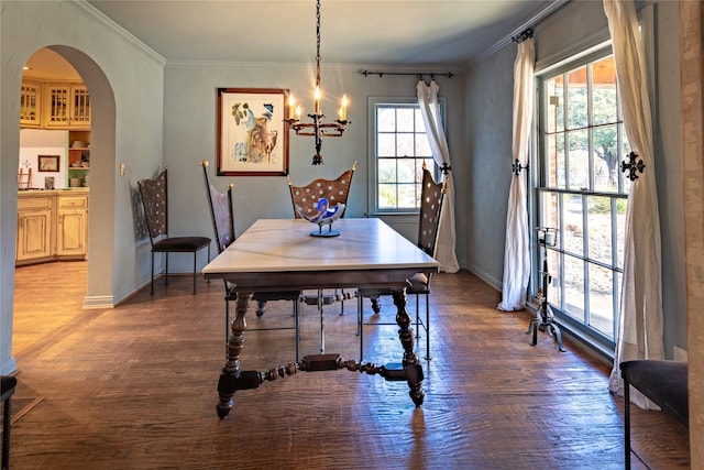 dining area featuring a chandelier, dark hardwood / wood-style floors, and ornamental molding