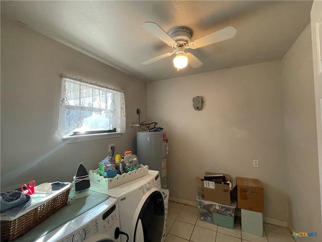 washroom with light tile patterned floors, electric water heater, ceiling fan, separate washer and dryer, and laundry area