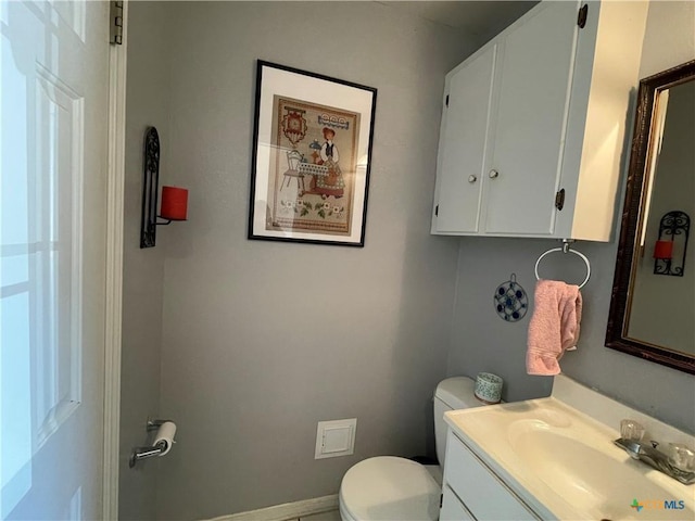 bathroom featuring toilet and vanity