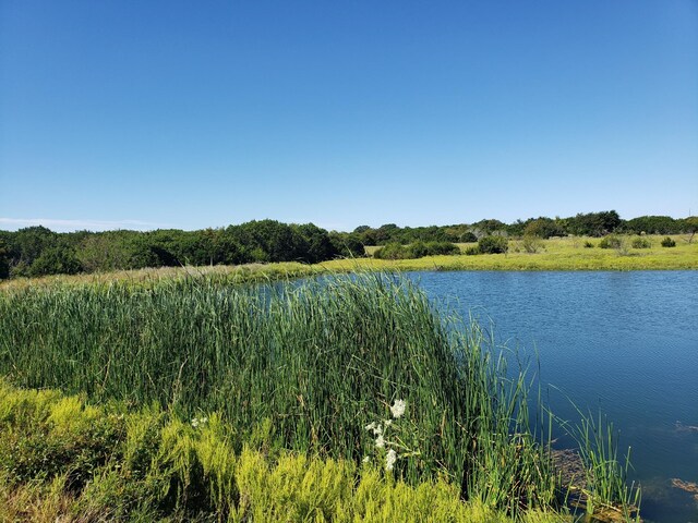 view of yard with a rural view and a water view