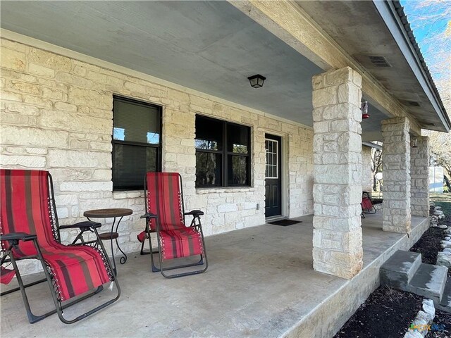 rear view of property featuring a carport and central air condition unit