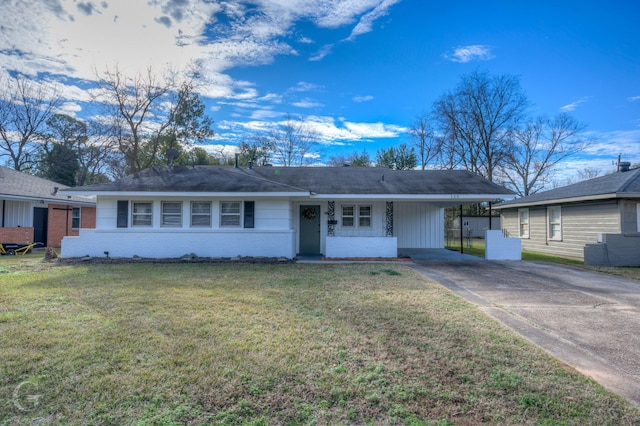 ranch-style house featuring a carport and a front lawn