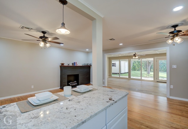 living room with a ceiling fan, light wood-style floors, baseboards, recessed lighting, and ornamental molding
