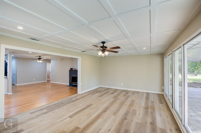 unfurnished living room featuring light wood-style flooring, baseboards, a ceiling fan, recessed lighting, and coffered ceiling