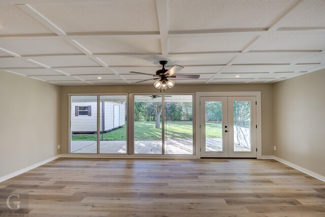 doorway to outside featuring french doors, ceiling fan, baseboards, light wood finished floors, and coffered ceiling