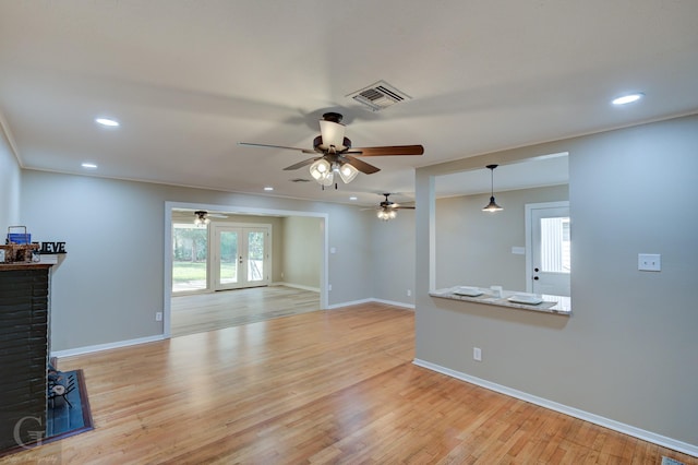 unfurnished living room with ceiling fan, baseboards, light wood-style floors, recessed lighting, and french doors
