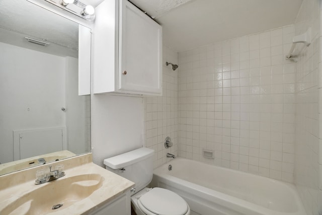 full bathroom with vanity, tiled shower / bath combo, and toilet