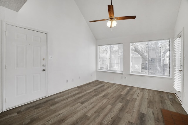 interior space with high vaulted ceiling, plenty of natural light, ceiling fan, and hardwood / wood-style flooring