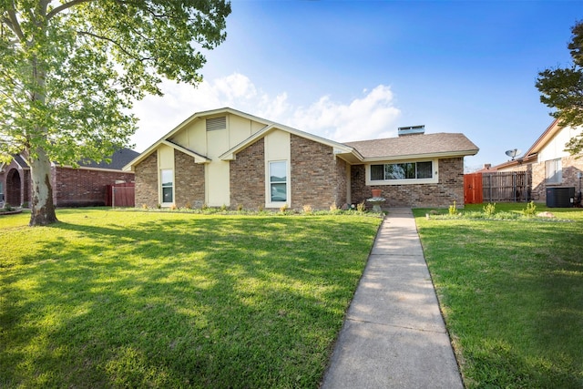 view of front of house featuring a front lawn and cooling unit