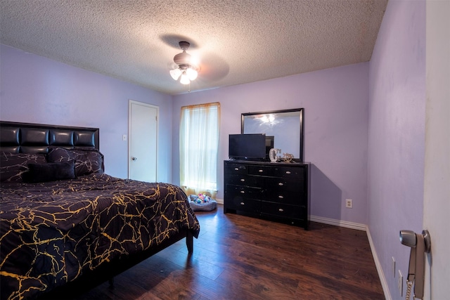 bedroom with ceiling fan, dark hardwood / wood-style floors, and a textured ceiling