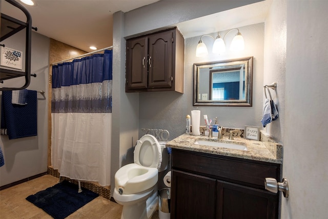 bathroom with a shower with curtain, tile patterned flooring, vanity, and toilet