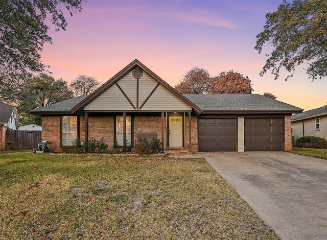 ranch-style house featuring a lawn and a garage