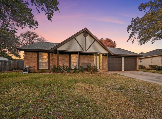 view of front of home with a yard and a garage