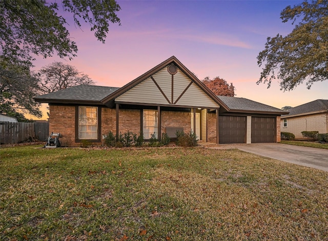 view of front of home with a garage and a yard