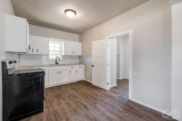 kitchen with dark wood-type flooring, white cabinets, sink, decorative backsplash, and black range with electric cooktop