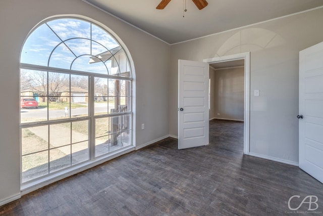 unfurnished room with ceiling fan, dark hardwood / wood-style floors, and ornamental molding