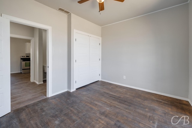 unfurnished bedroom featuring a closet, ceiling fan, and dark wood-type flooring