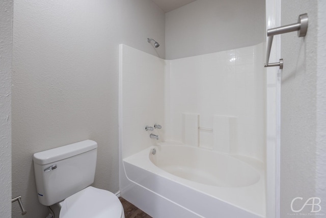 bathroom with shower / tub combination, wood-type flooring, and toilet