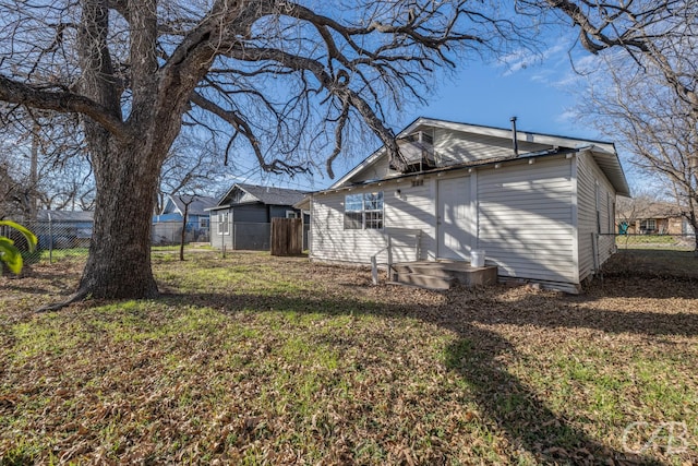 back of house with a lawn