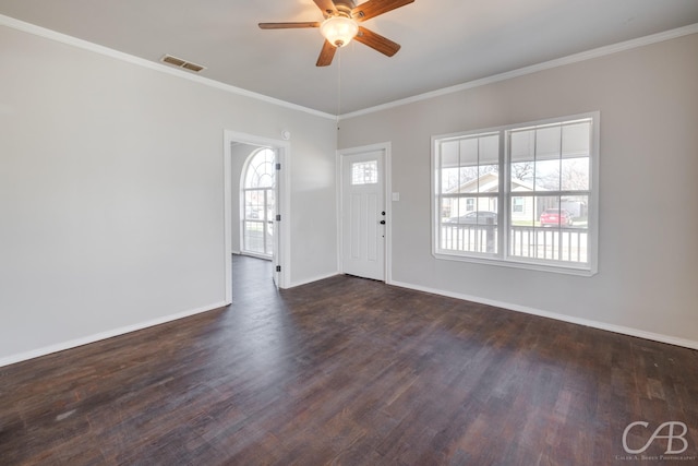 entrance foyer with dark wood-type flooring, ceiling fan, and ornamental molding