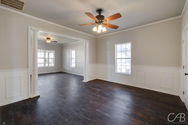 spare room with dark wood-type flooring, ornate columns, and crown molding