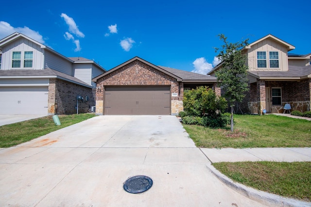 view of front of property featuring a front yard and a garage