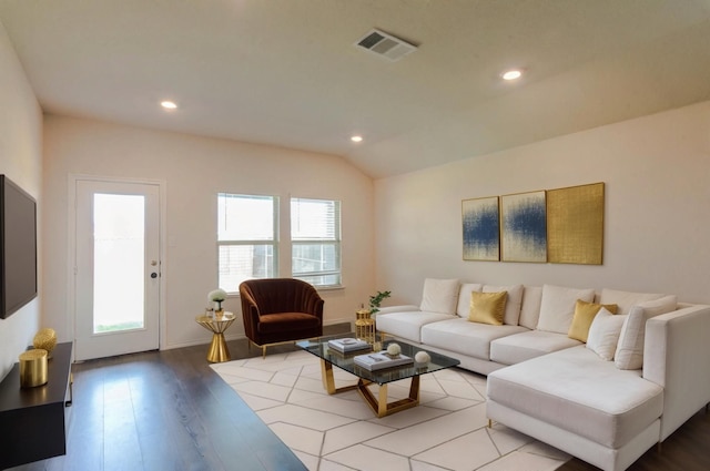 living area featuring lofted ceiling, light wood-style flooring, visible vents, and recessed lighting